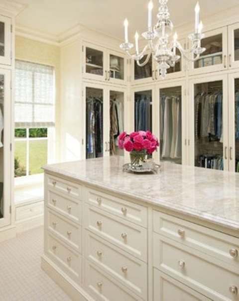 white walk-in closet with chandelier